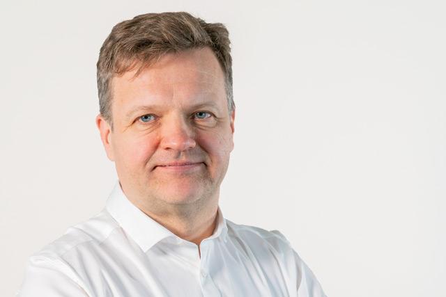 A confident man wearing white shirt